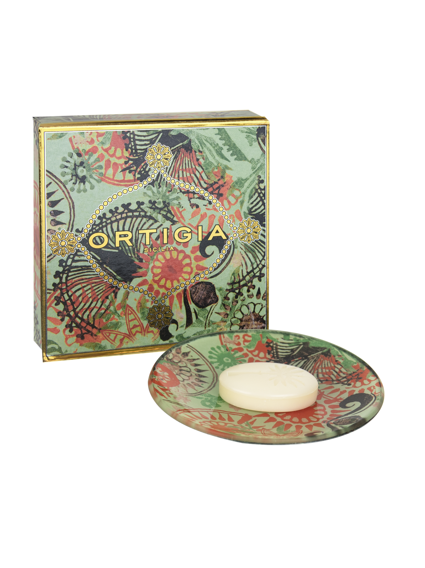 A glass plate with a printed design featuring green and orange floral patterns, alongside a bar of soap.