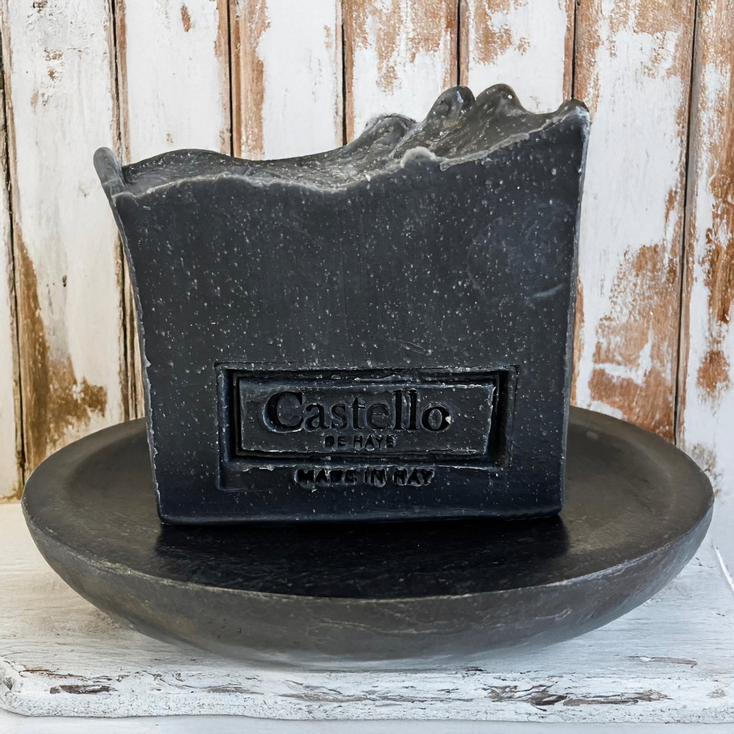 Black mountain charcoal soap on an oval black soap dish