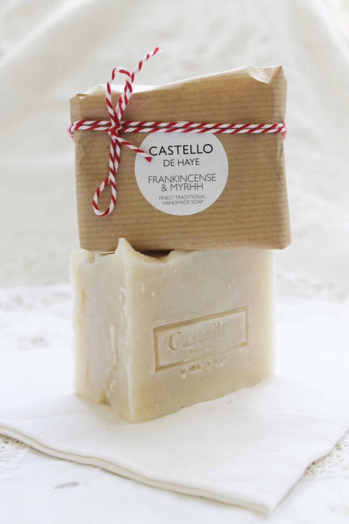 Large soap with wrapped soap on top on linen sheet