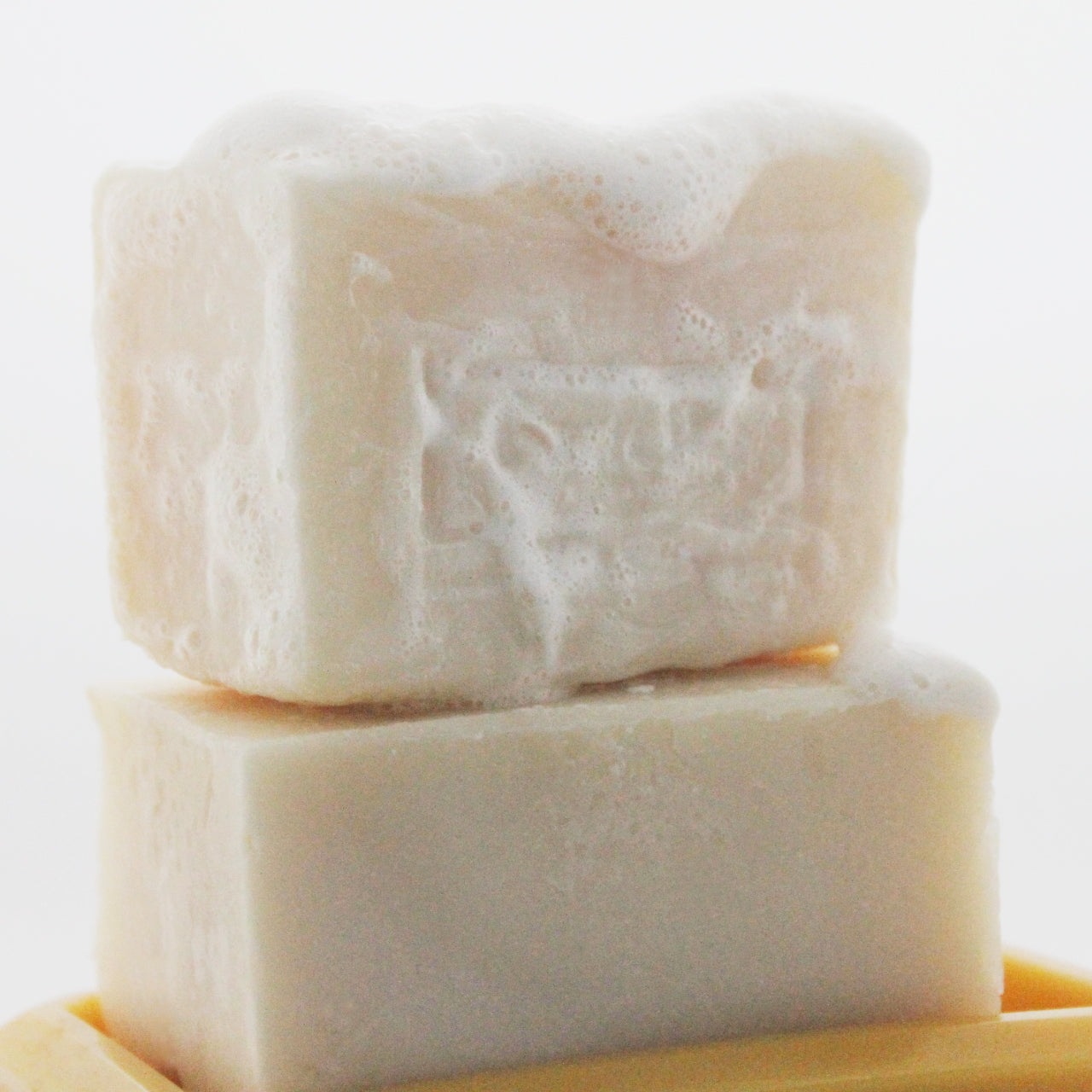 Soap with suds on a beeswax soap dish
