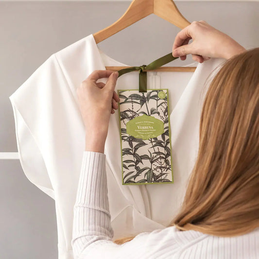 Castelbel Verbena scented sachet held beside a clothes hanger.