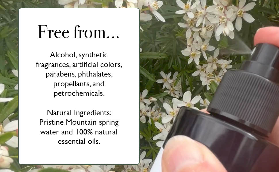 Bottle of natural product with text about ingredients on a background of greenery and flowers.