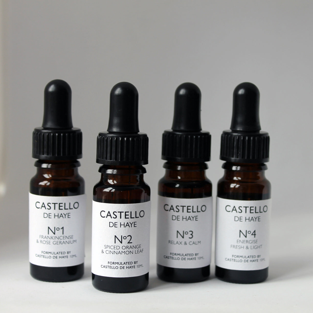 Four bottles in a row on white background, No.1, No.2, No.3 and No.4 mixes of essential oil