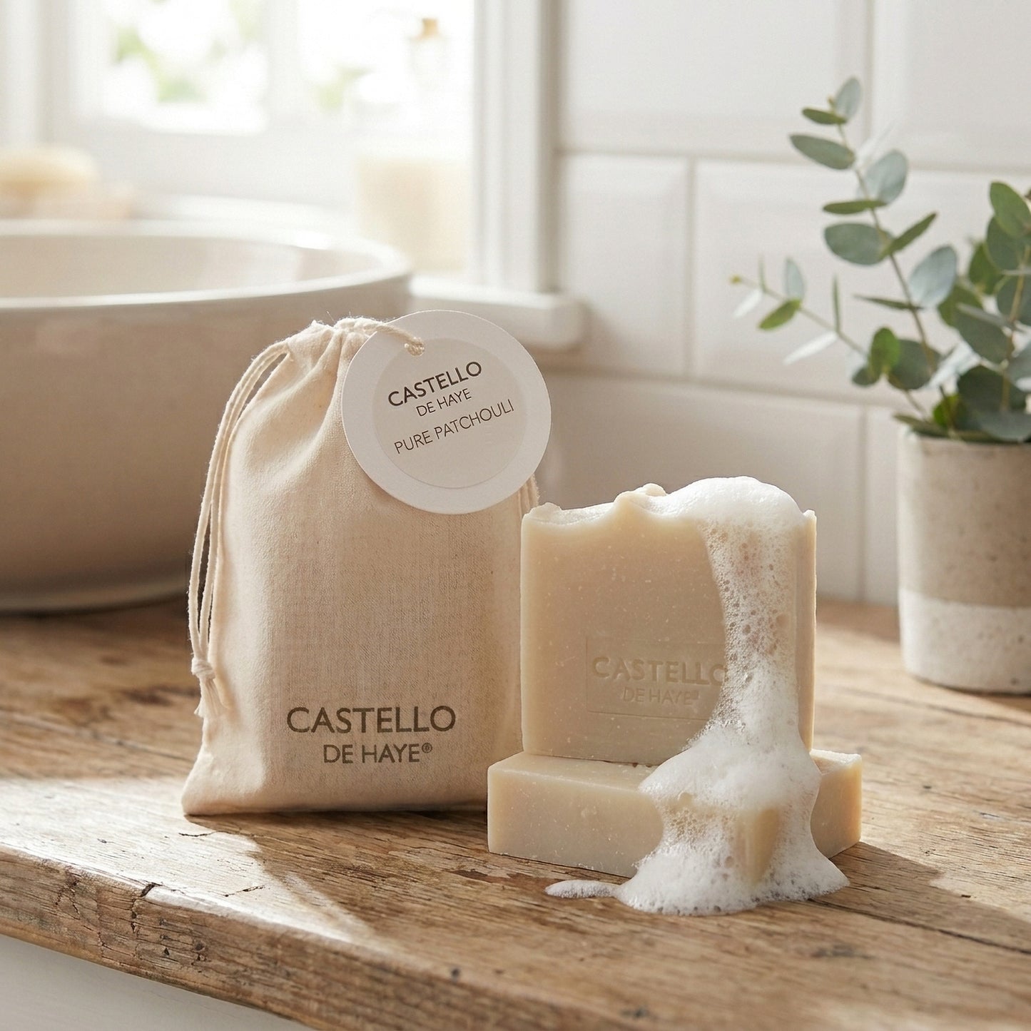 Pure patchouli soap, 100g and 40g with lather and giftbag in bathroom setting