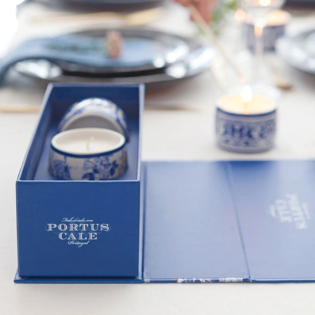 Portus Cale Gold & Blue candle set in patterned ceramic holders, styled on a dining table
