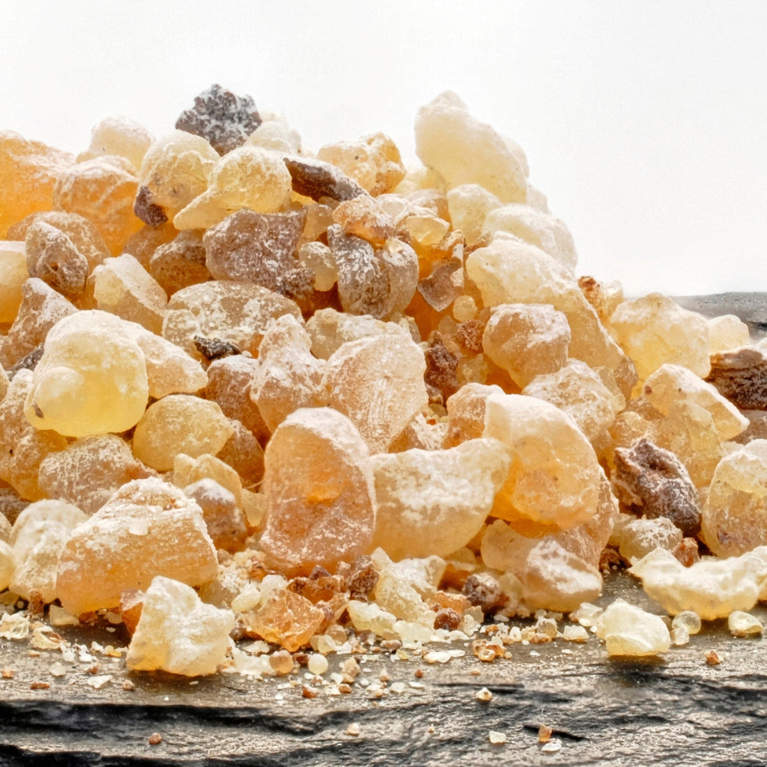 Golden nuggets of Frankincense resin on a slate tray