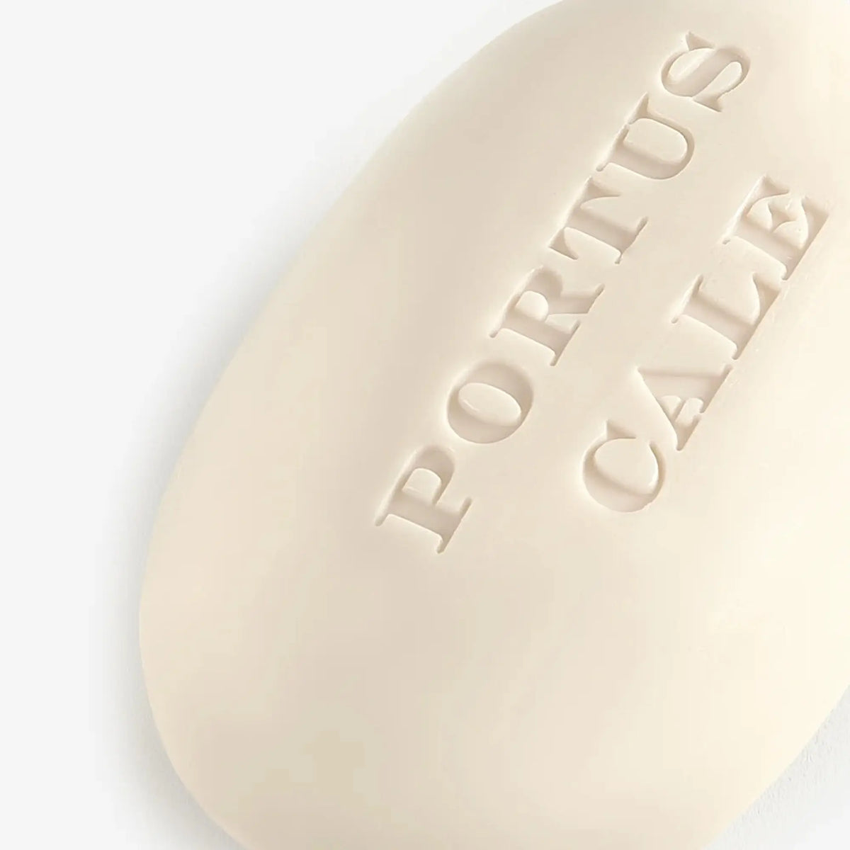 Close-up of Portus Cale Rosé Blush soap bar showing embossed brand lettering, 150g vegetable soap