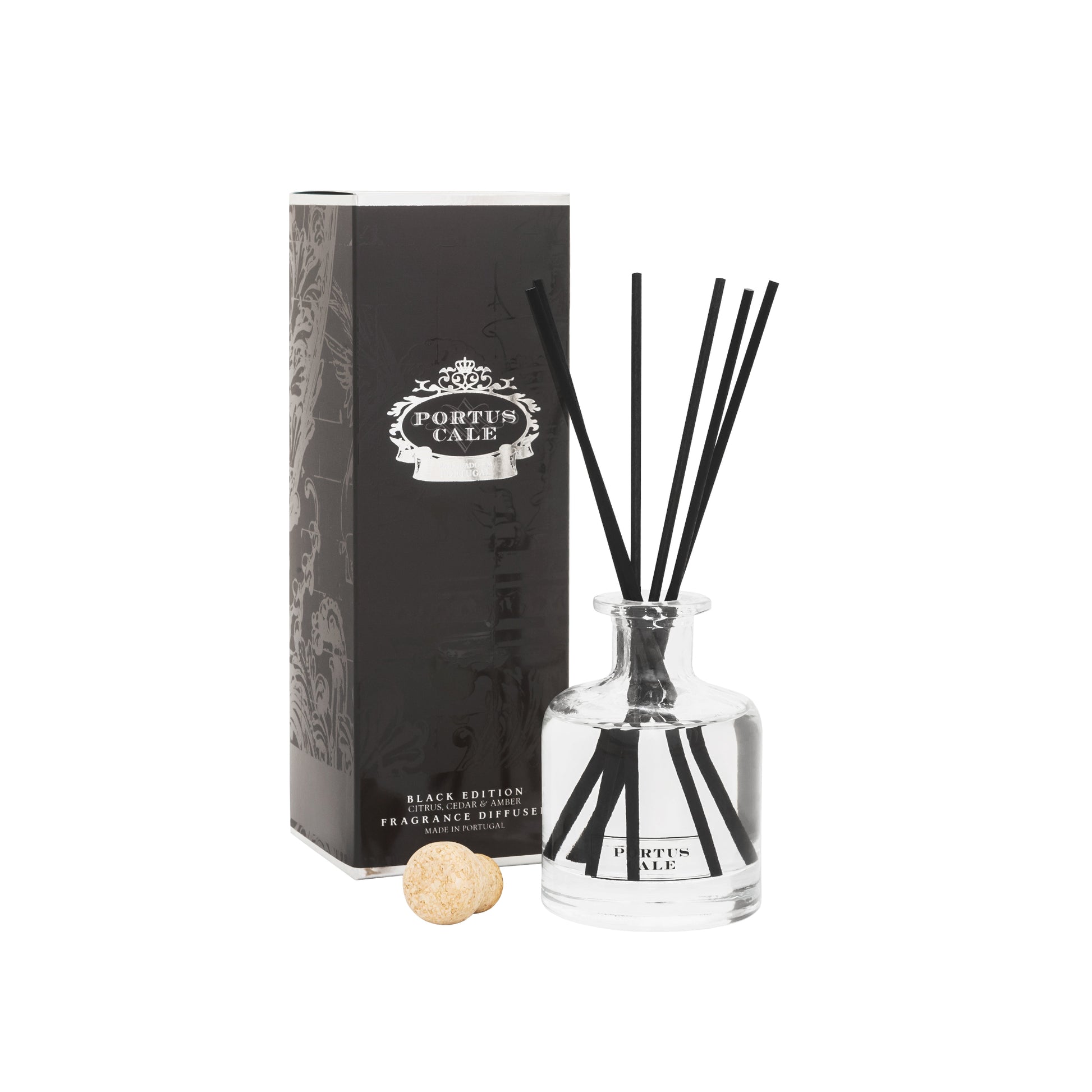 Portus Cale Black Edition Diffuser, with a sleek black and turquoise packaging, adorned with Portuguese tile motifs. The set includes a glass diffuser bottle, black sticks, and a cork stopper.