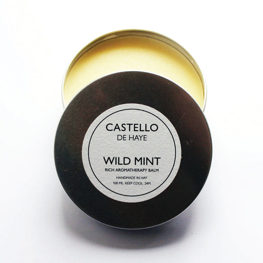 A tin container of Castello de Haye Wild Mint Aromatherapy Balm with the label on the lid.
