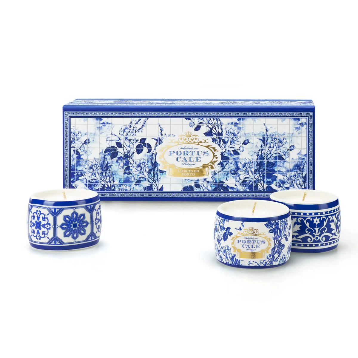 Three Portus Cale Gold & Blue candles in blue and white patterned ceramic holders, beside their matching gift box