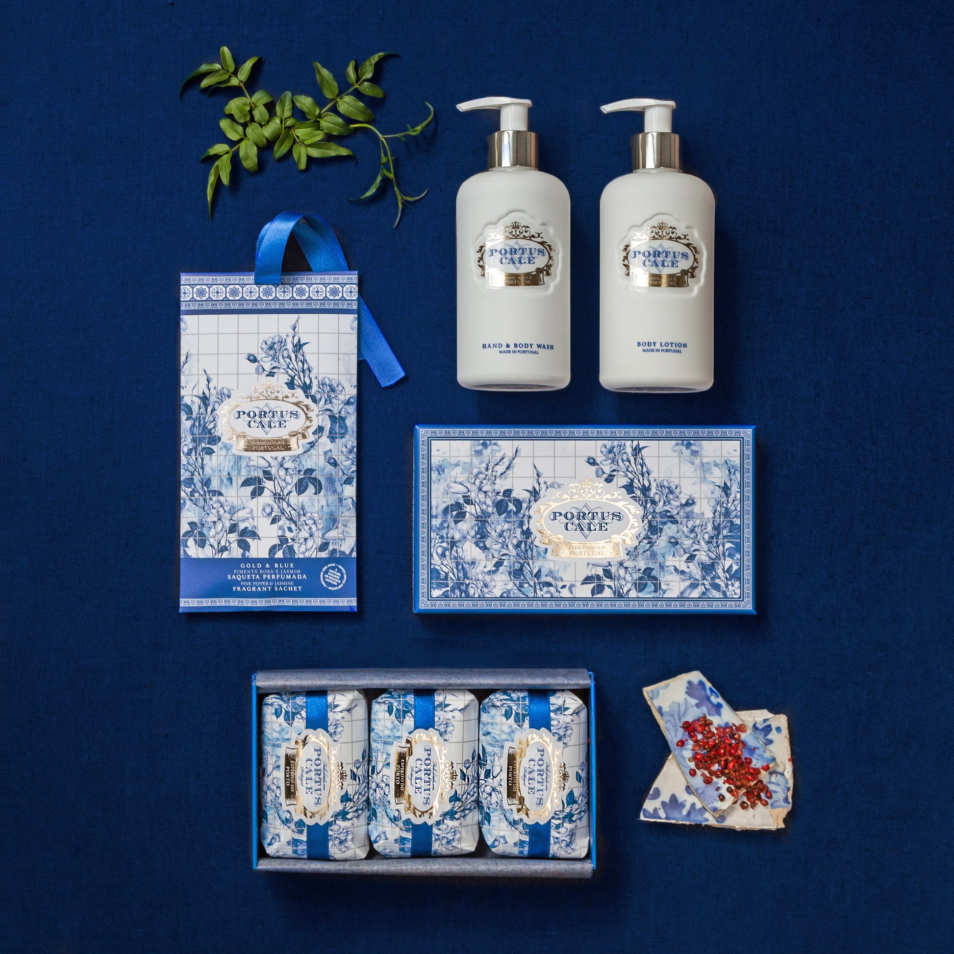PortusCale_Gold_Blue_300mL_wash_and_lotion on a blue background pink pepper