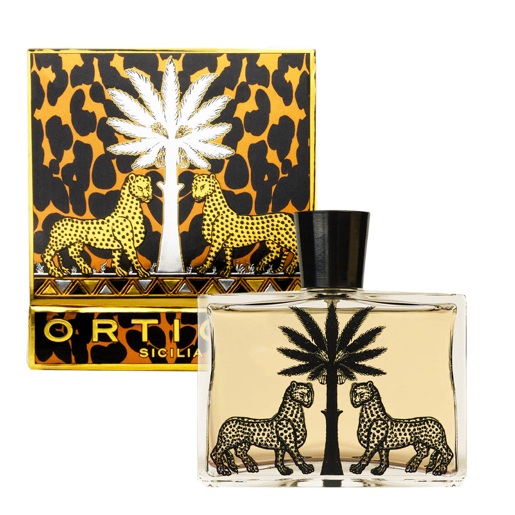 Perfume bottle and packaging with leopard and palm tree design on a white background