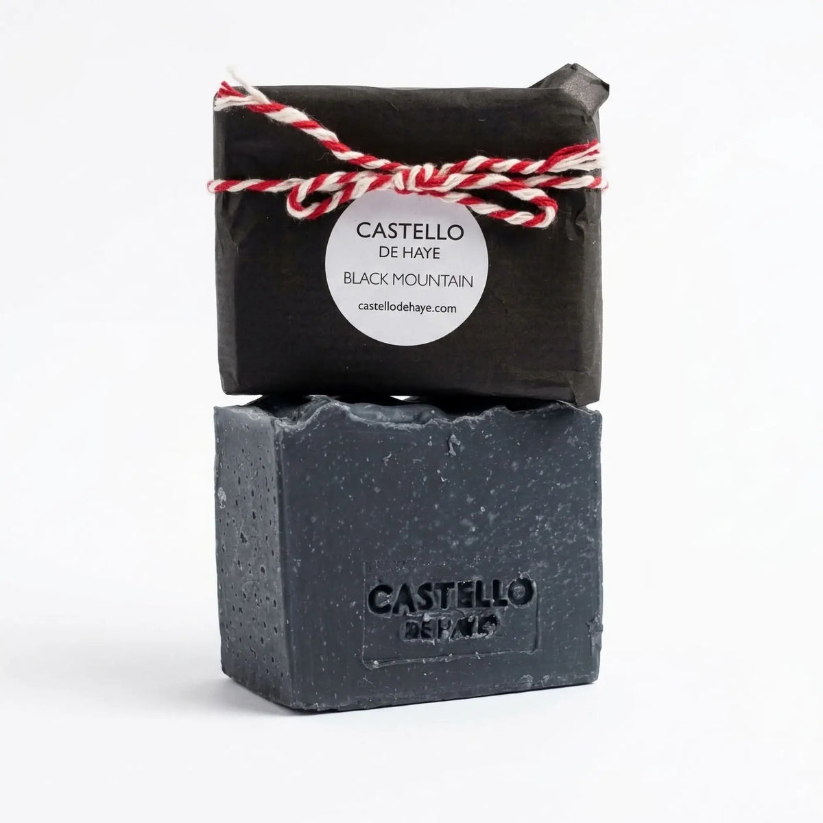 Castello de Haye Activated Charcoal & Pine Leaf soap bars, wrapped and unwrapped, on a white background