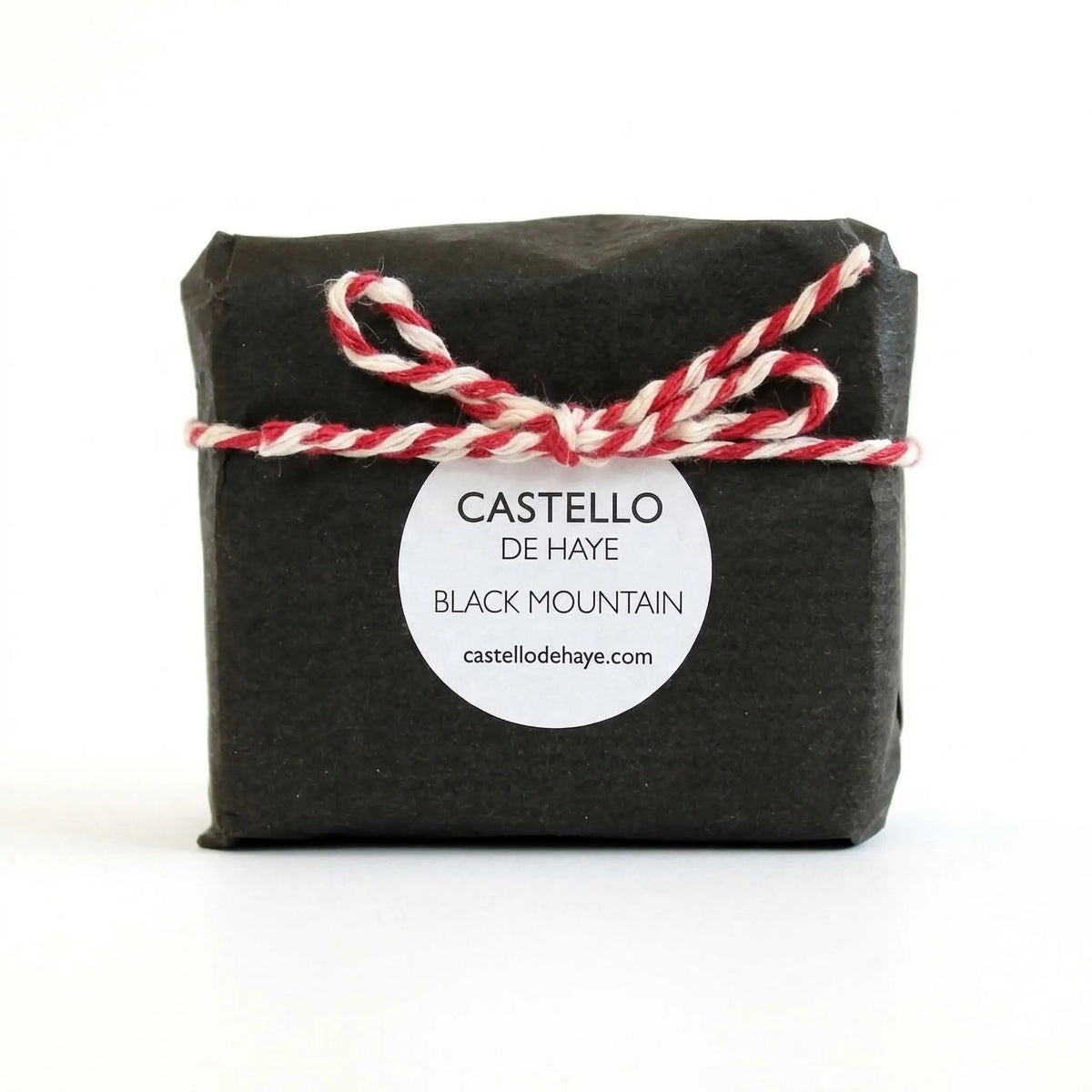 Activated charcoal soap bar with pine essential oil on natural surface - handmade detox skincare by Castello de Haye