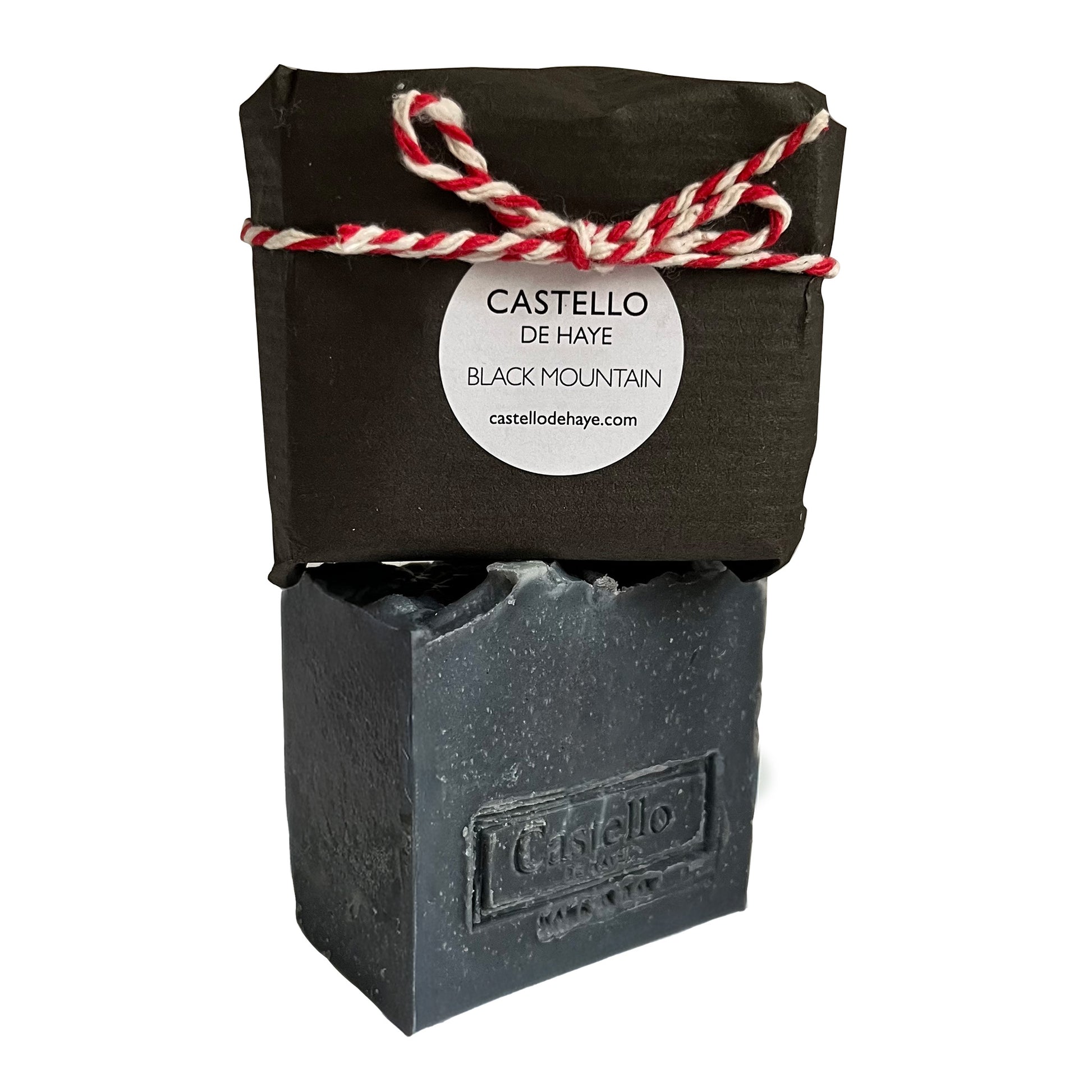 Black soap bar with packaging featuring 'Castello de Haye' branding on a white background
