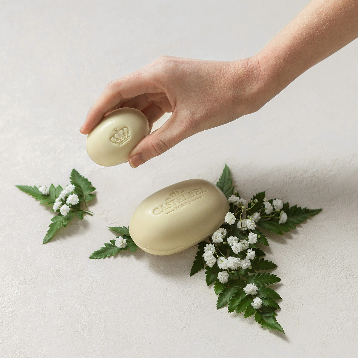 Castelbel soaps with hand picking up the 40gram soap with white flowers