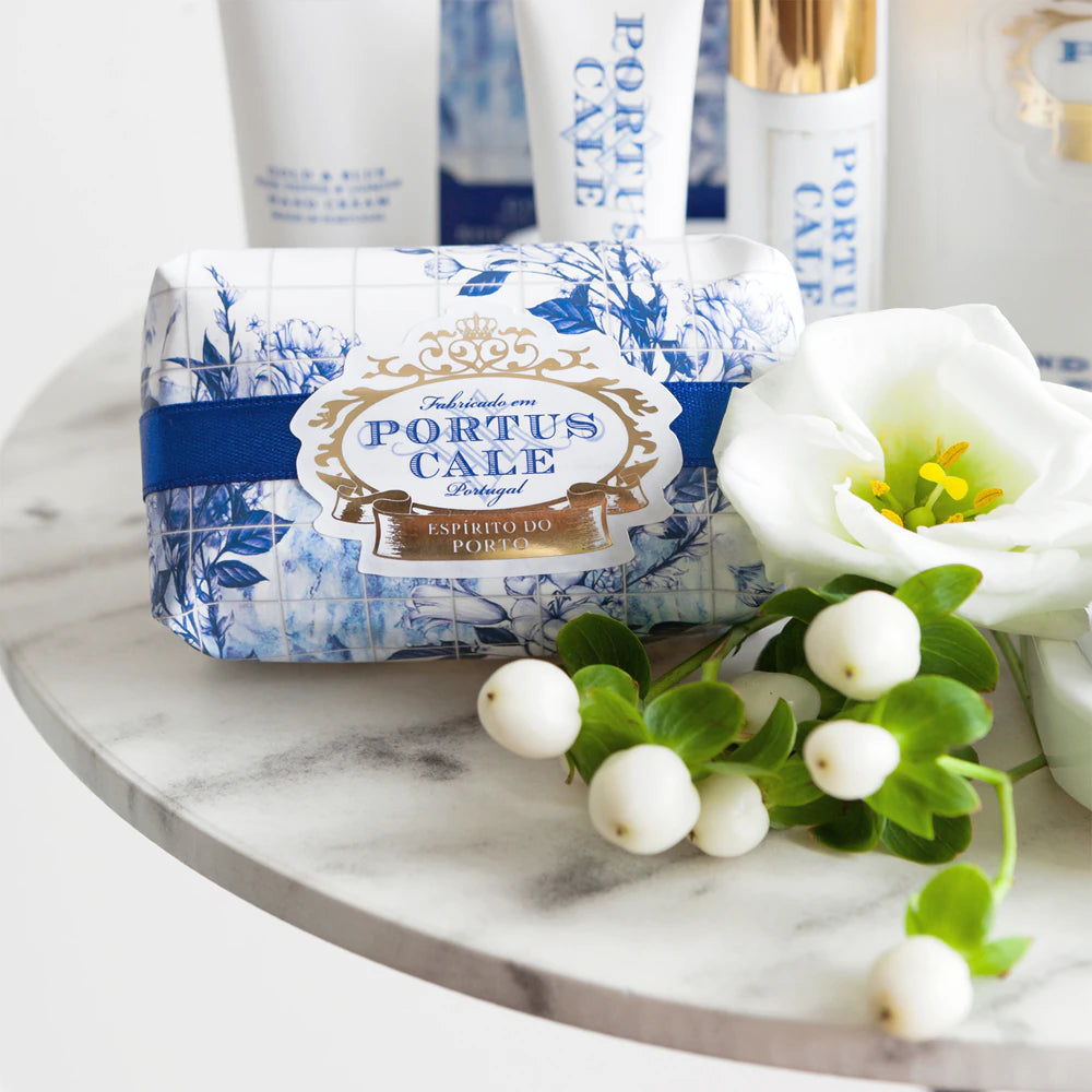Portus Cale Gold & Blue 150g soap bar with flowers on a marble surface