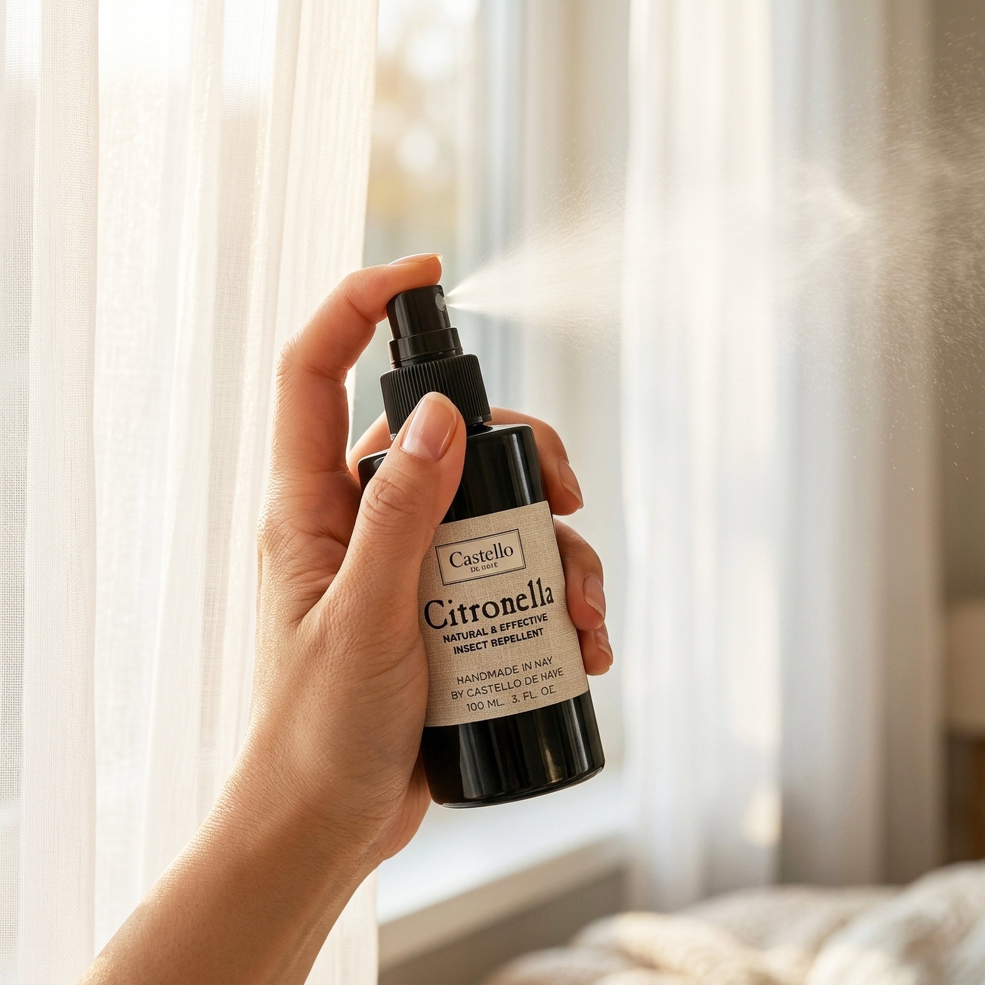 Citronella Room Spray being misted by a woman's hand