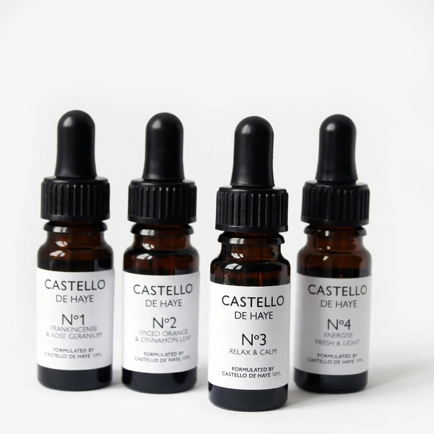 Castello de Haye pure essential oil range — No.1, No.2, No.3 and No.4 amber apothecary dropper bottles on grey background