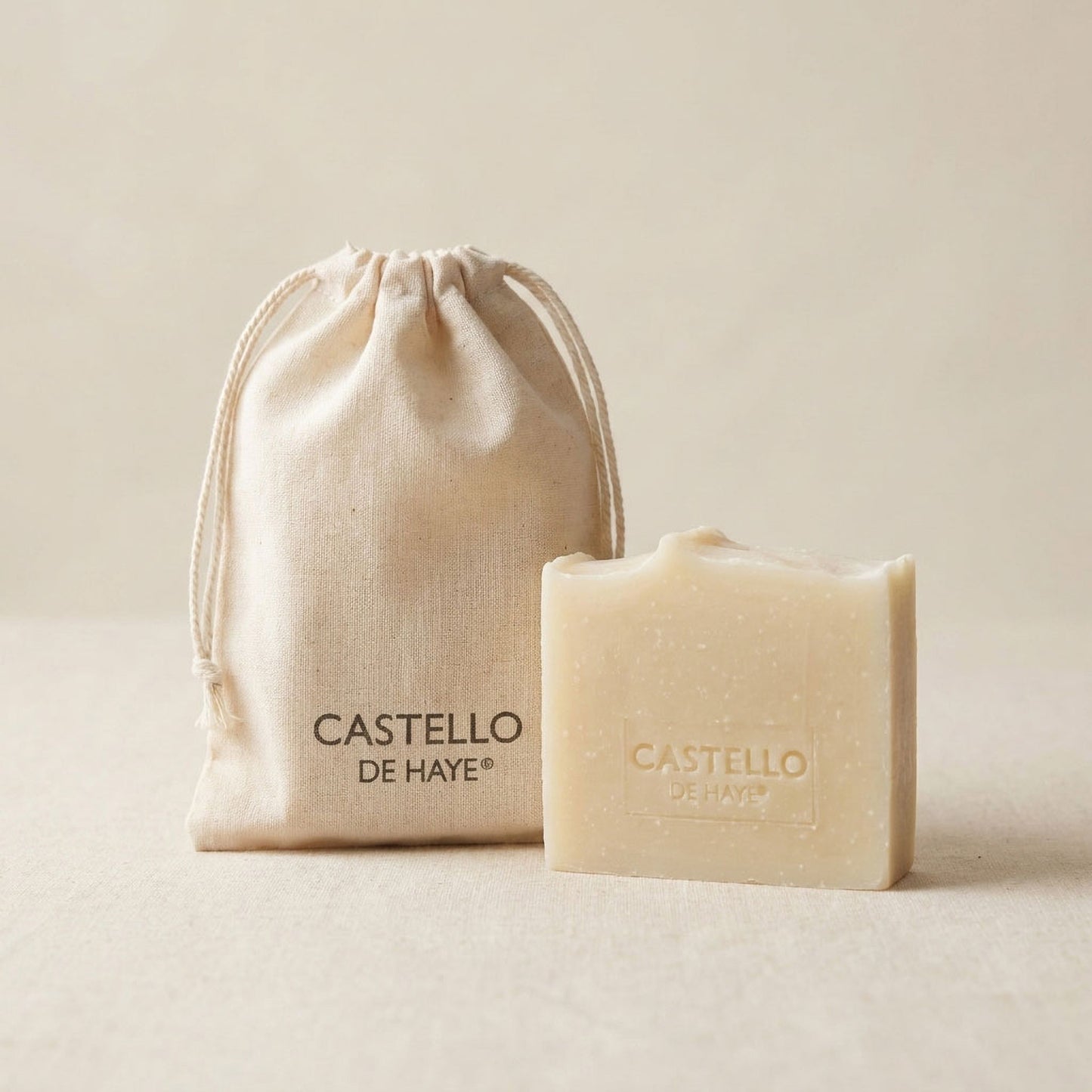 Pure patchouli handmade soap bar next to a natural cotton muslin gift bag – artisan skincare by Castello de Haye