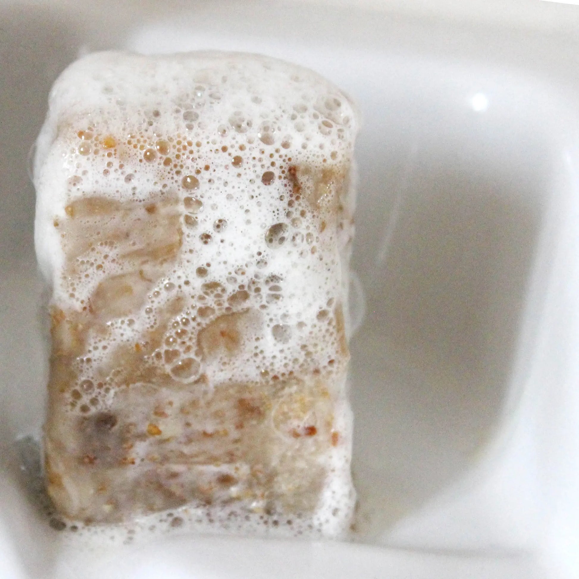 Honey and oat exfoliating soap bar with lather on wooden soap dish - benzoin essential oil 200g