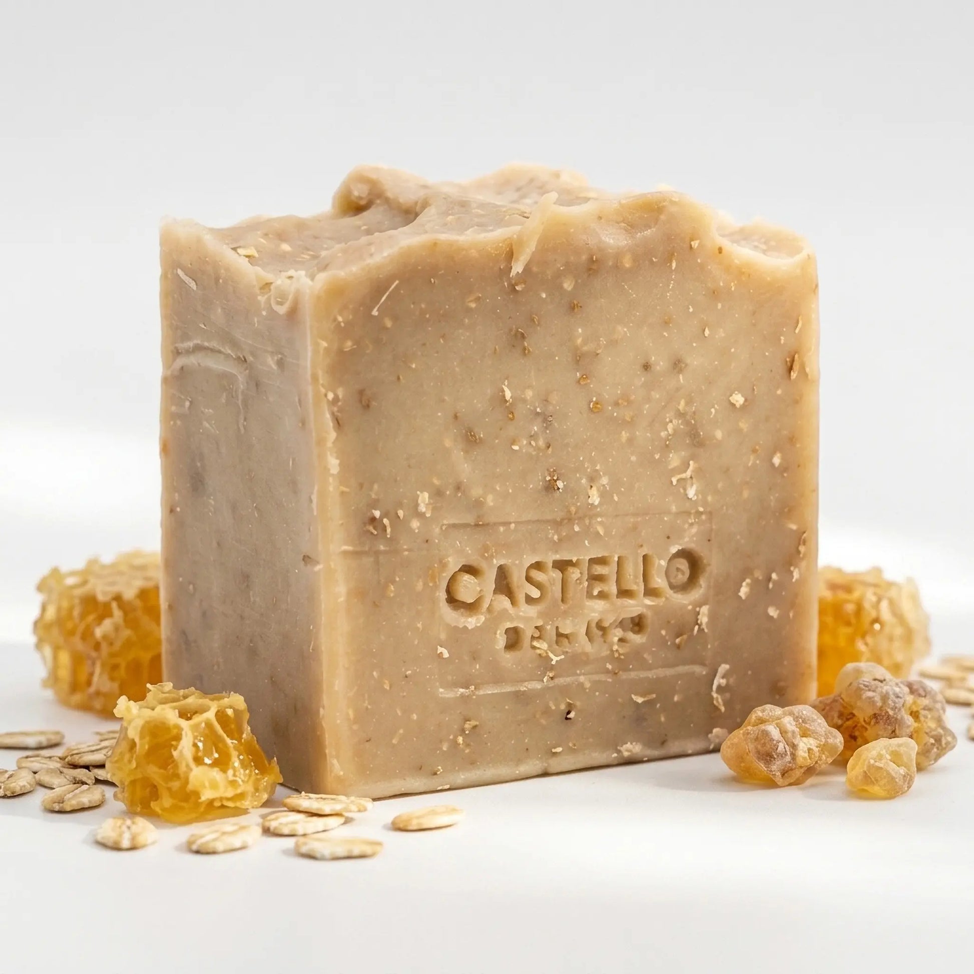 Castello de Haye Honey & Oat handmade soap bar with honeycomb pieces, oats and benzoin resin on white background