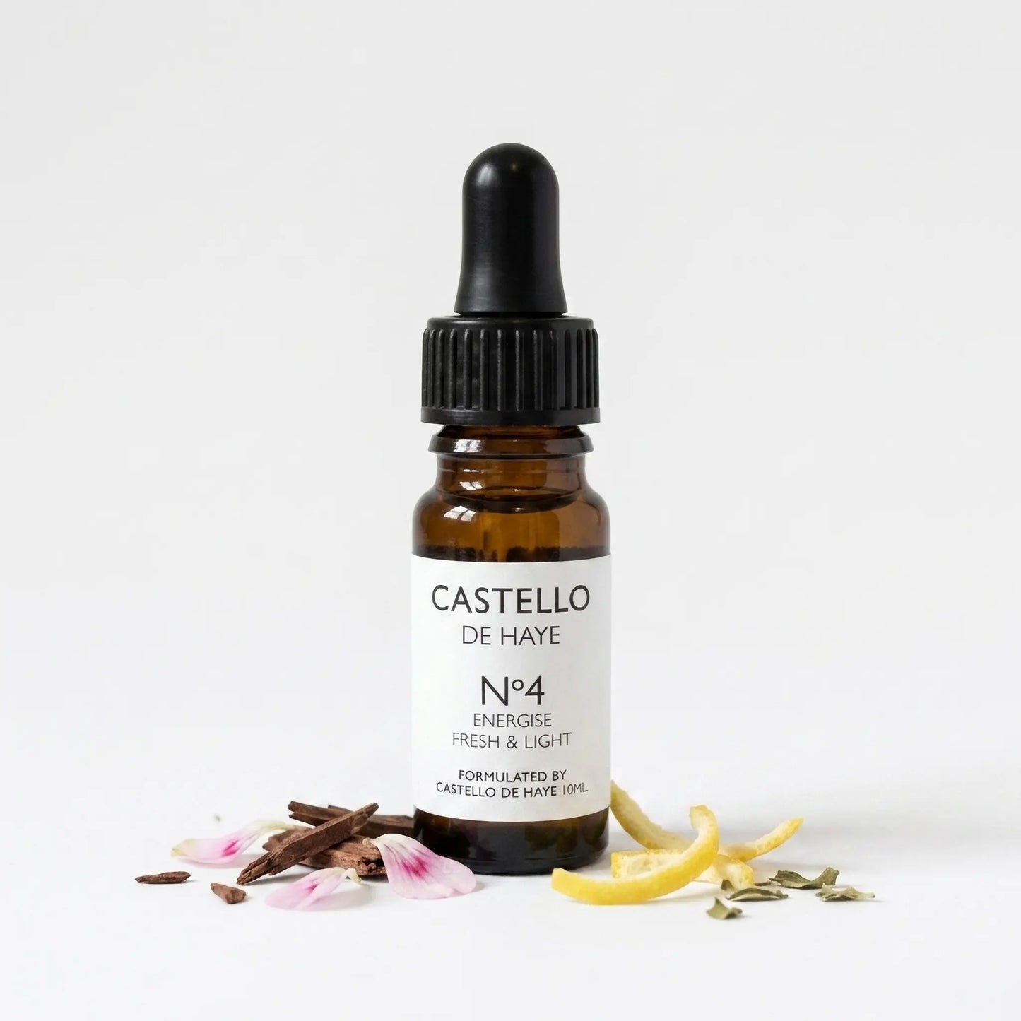 No.4 Energise essential oil blend in a 10ml amber apothecary glass bottle with pipette, surrounded by cedarwood shards, lemon, rose geranium and petitgrain botanicals