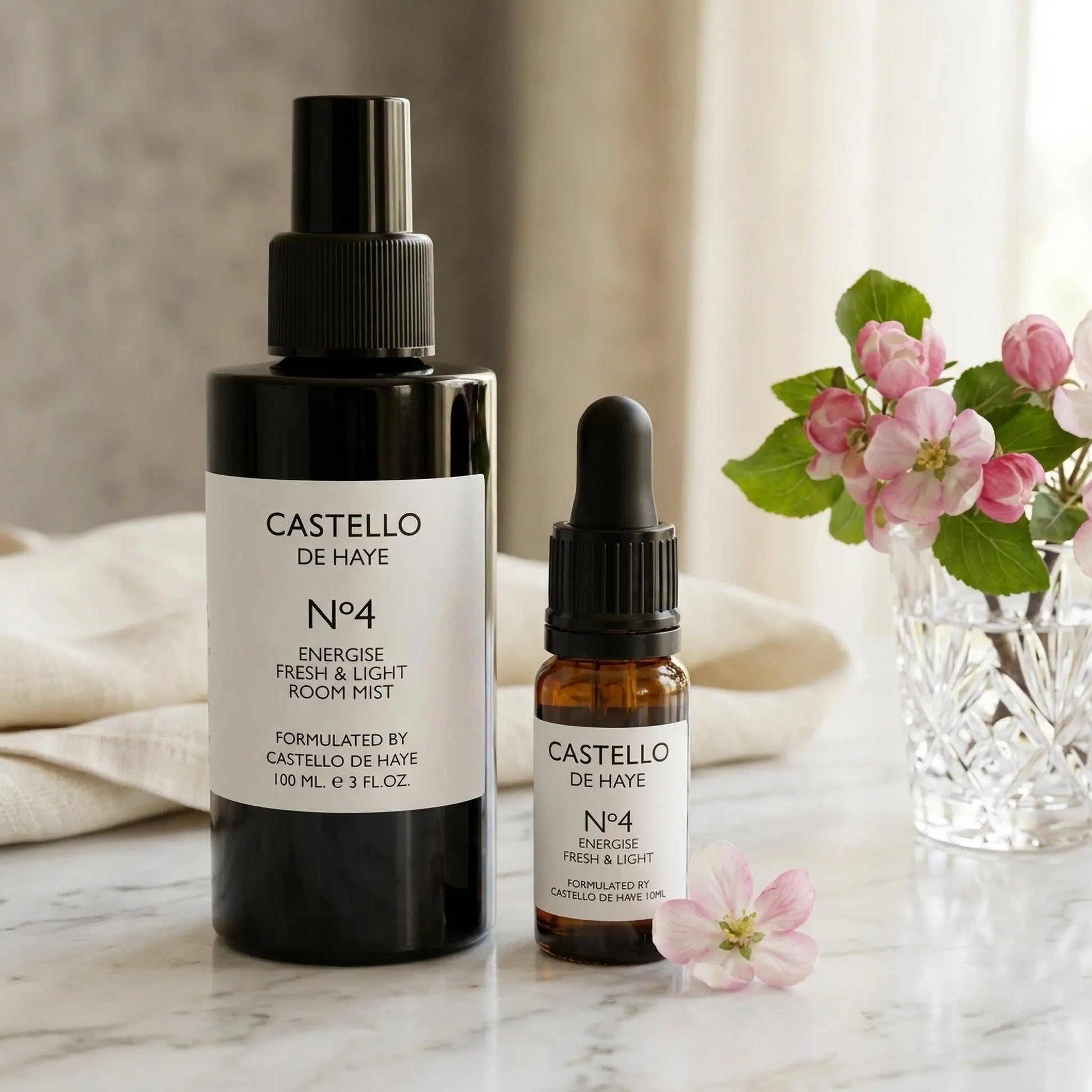 No.4 Energise 100ml room mist spray bottle alongside a 10ml essential oil bottle — Castello de Haye aromatherapy collection