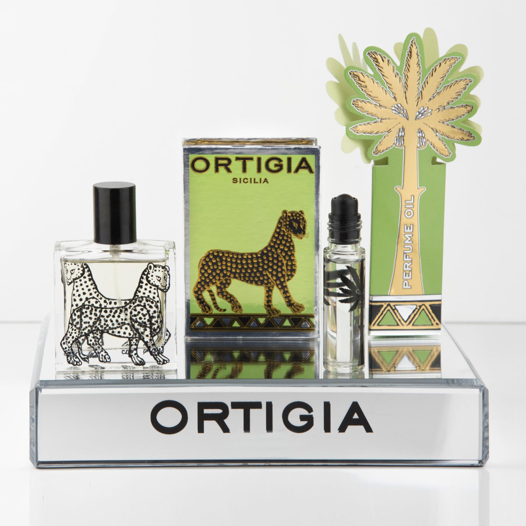 Perfume bottles and packaging with 'Ortigia' branding on a white background