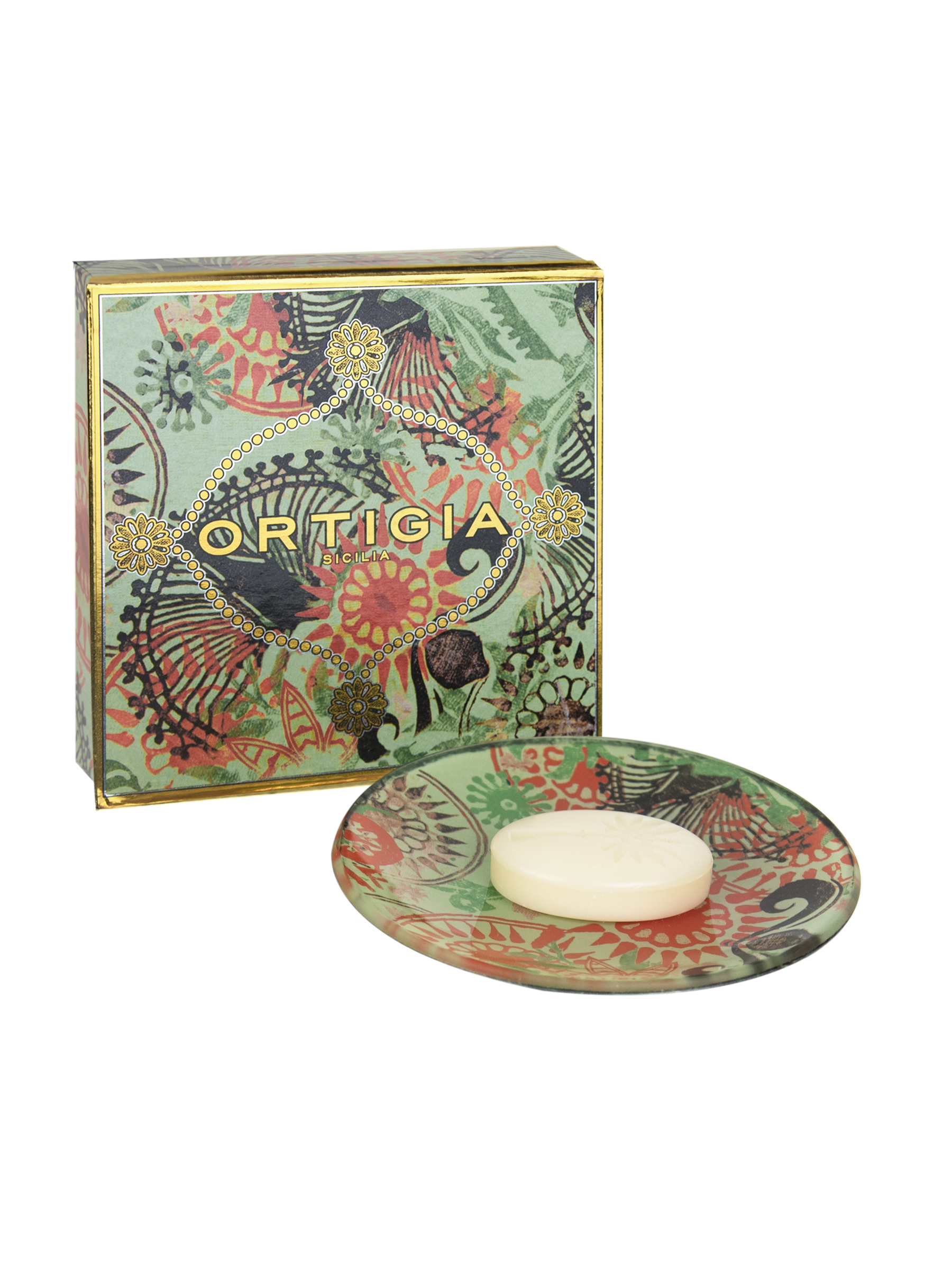 A glass plate with a printed design featuring green and orange floral patterns, alongside a bar of soap.