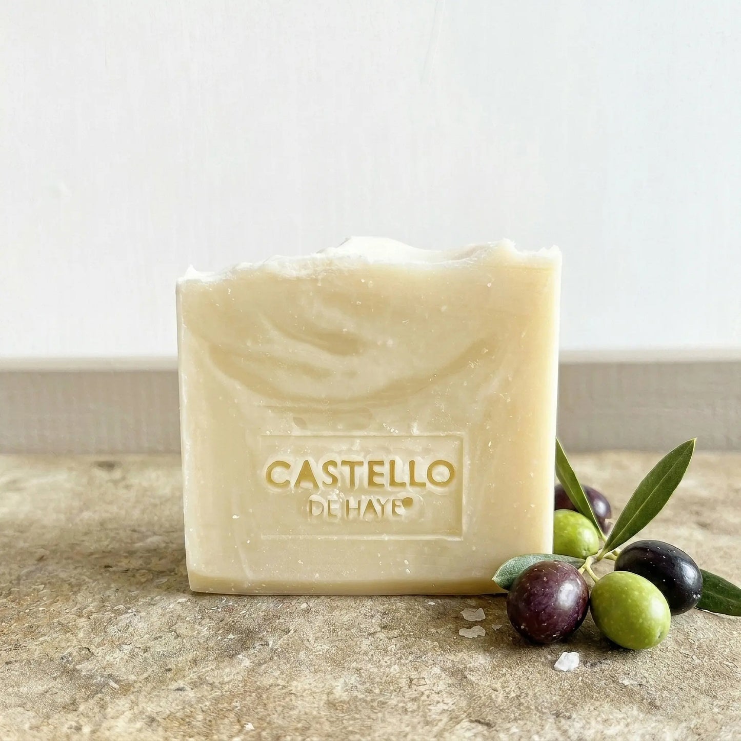 Pure olive soap bar 200g with olive branches scattered around the base