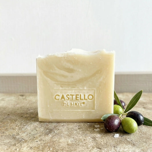 Pure olive soap bar 200g with olive branches scattered around the base
