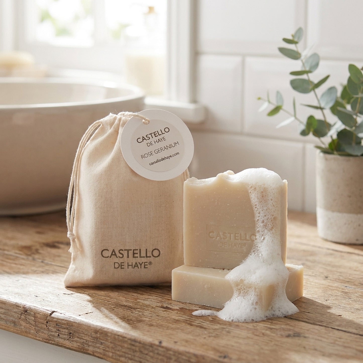 Castello de Haye gift soap with gift-bag on a wooden surface in a bathroom setting