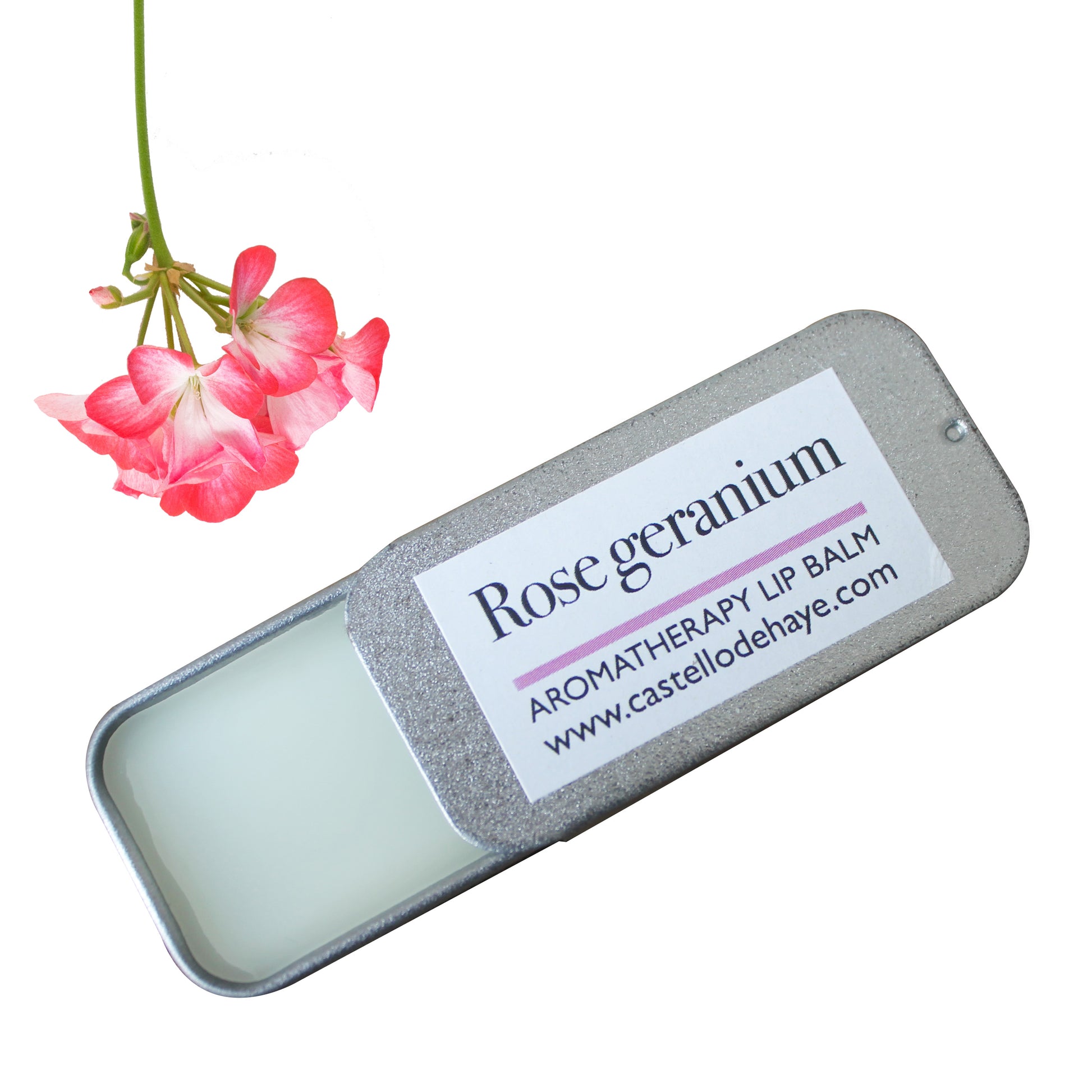 Rose geranium lip balm in a tin with a pink flower on a white background
