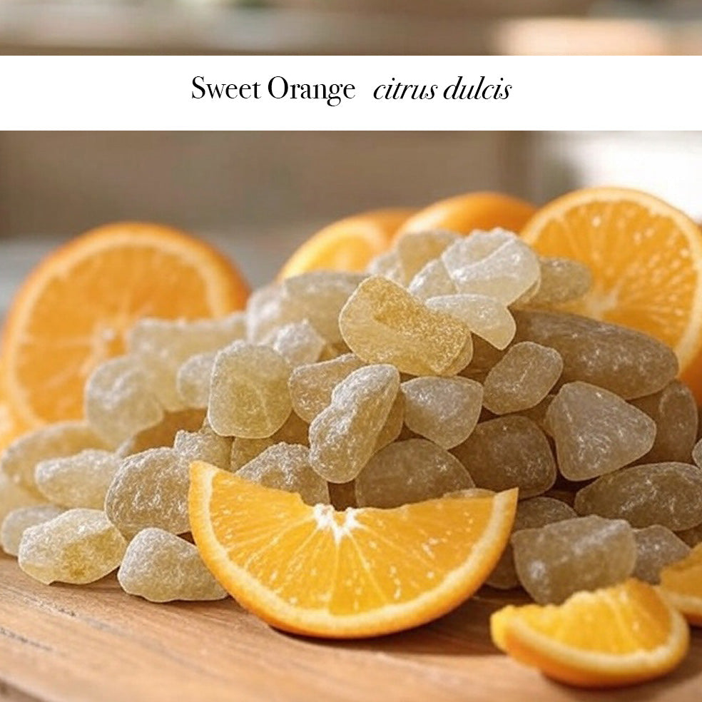Frankincese crystals and slices of orange mixed together on a wooden shelf with a label over the top Sweet Orange citrus dulcis